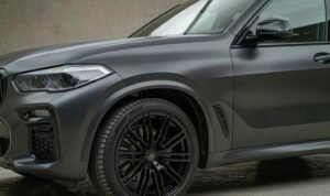Satin PPF finish on a dark grey SUV hood under soft studio light